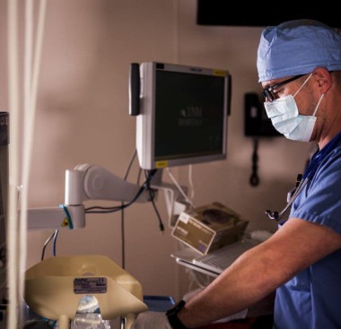 A medical professional in a clinical or surgical environment