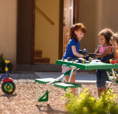 Children playing together at a picnic table